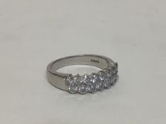 A platinum diamond dress ring, of twin offset rows of eight uniform round brilliant-cut stones