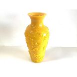 A Peking glass baluster form vase, in yellow, decorated in relief with a dragon and figures by a
