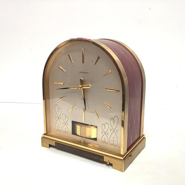An unusual Jaeger le Coultre lacquered brass Atmos timepiece, 1960's, the case of arched form,
