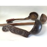 A coconut shell and carved wooden ladle, possibly Papua, New Guinea, the handle carved in relief