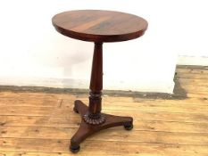 A George IV rosewood occasional table, the circular top raised on a turned lotus-carved pillar