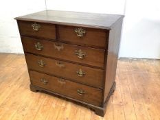 A George III oak chest, with two short and three long drawers, raised on bracket feet (possibly