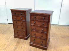 A pair of Victorian mahogany bedside chests, each with five graduated drawers, raised on a plinth