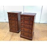 A pair of Victorian mahogany bedside chests, each with five graduated drawers, raised on a plinth