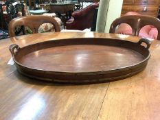 A George III mahogany, brass-mounted and boxwood strung tray, of oval form with loop handles, the