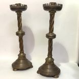 A pair of large Gothic Revival brass altar sticks, 19th century, each candle sconce within a