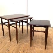 A set of three Danish rosewood graduated tables, c. 1965, each rectangular crossbanded top with