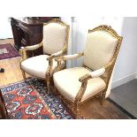 A pair of 19th century giltwood armchairs, in the French taste, each cresting rail with beaded and