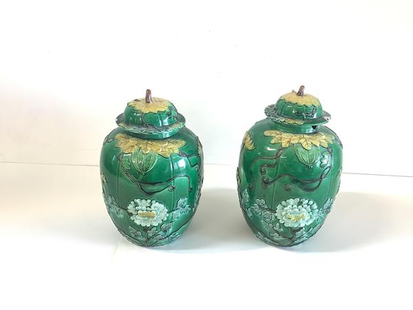 A pair of Chinese green-glazed biscuit porcelain jars and covers, late 19th century, each of ovoid