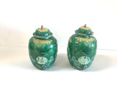 A pair of Chinese green-glazed biscuit porcelain jars and covers, late 19th century, each of ovoid