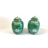 A pair of Chinese green-glazed biscuit porcelain jars and covers, late 19th century, each of ovoid