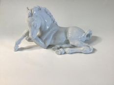 A Meissen porcelain model of a seated foal, 20th century, glazed in the white, underglaze blue