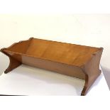 An unusual late 19th century solid sycamore book trough, with undulating sides and moulded feet.