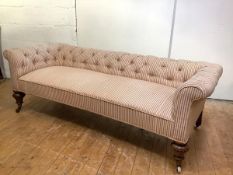 A country house three seat sofa, c. 1870, the low buttoned back and arms and padded seat in