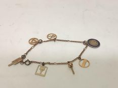 A 9ct gold charm bracelet, of dainty curb links, suspending 9ct gold charms including a blue