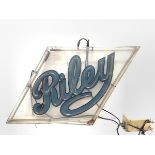 A large neon advertising sign for Riley Cars, in a lozenge-shaped frame. 59cm by 102cm