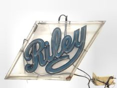 A large neon advertising sign for Riley Cars, in a lozenge-shaped frame. 59cm by 102cm