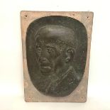 A bronze portrait roundel, early 20th century, of a gentleman, unsigned, mounted on a stone