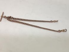 A 9ct gold Albert watch chain, of graduated curblinks, with t-bar and pair of lobster clasps. Length