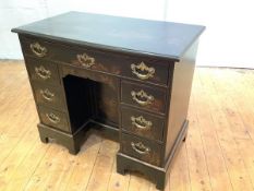 A George II style painted kneehole desk, the rectangular top above a frieze drawer, a panelled