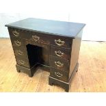 A George II style painted kneehole desk, the rectangular top above a frieze drawer, a panelled