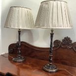 A pair of modern painted turned wooden table lamps, of slender baluster form, gilt-painted with