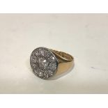An 18ct gold diamond cluster ring, the central round brilliant-cut stone weighing approx. 0.60ct,