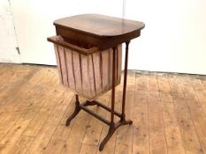 A 19th century rosewood work table, the hinged boxwood-strung top with rounded ends, above a pull-