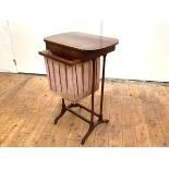 A 19th century rosewood work table, the hinged boxwood-strung top with rounded ends, above a pull-