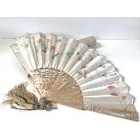 A late 19th century painted and embroidered silk and abalone fan, probably French, painted with