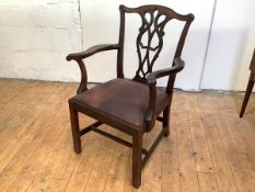 A Scottish George III mahogany elbow chair, the moulded yoke shaped cresting rail with foliate