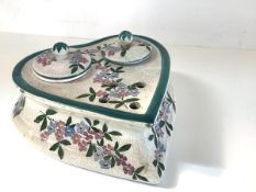 A Wemyss Ware ink stand, of heart shape, with twin covered inkwells, painted with floral sprays,