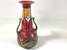 A Minton Secessionist No. 8 twin-handled vase, painted in a palette of red, green and mustard,