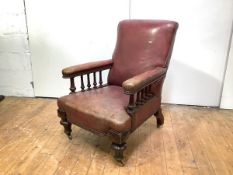 A Victorian mahogany framed library chair, the back, arms and seat upholstered in faded red leather,
