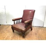 A Victorian mahogany framed library chair, the back, arms and seat upholstered in faded red leather,