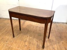 A George III mahogany and ebony lined tea table, the hinged rectangular top with rounded and