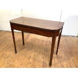 A George III mahogany and ebony lined tea table, the hinged rectangular top with rounded and