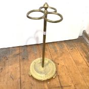 An Edwardian brass stick stand, with urn finial and three hoop divisions, on a turned column and