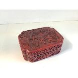 A Chinese red cinnabar lacquer box and cover, c. 1900, of shaped rectangular form, the lift-off