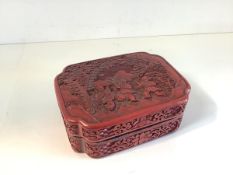A Chinese red cinnabar lacquer box and cover, c. 1900, of shaped rectangular form, the lift-off