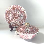 A Chinese Export porcelain tureen on stand, the circular tureen with shallow domed cover and