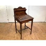 An Edwardian rosewood and boxwood-lined writing desk of small proportions, the raised gallery with