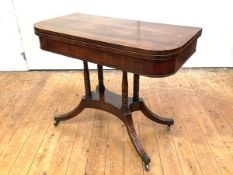 A Regency mahogany card table, c. 1820, the hinged rectangular crossbanded top enclosing a baize