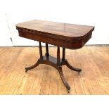 A Regency mahogany card table, c. 1820, the hinged rectangular crossbanded top enclosing a baize