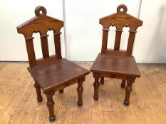 A pair of late 19th century pitch pine hall chairs, the rectangular back of anchor form with loop