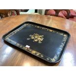 A late 19th century black japanned toleware galleried tray, rectangular, centred by a lacquered gilt