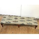 A modern long footstool upholstered with fish design, on cabriole legs ending in pad feet (24cm x