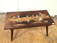 A modern South East Asian coffee table, with inlaid design depicting Figures Fishing, on tapering