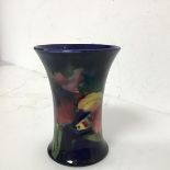 A Moorcroft vase in fruit and flower pattern, stamped Potter to HM the Queen to base (11cm x 8cm)