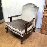 A reproduction chair in the Georgian style, of large proportions, with soft grey velvet upholstery